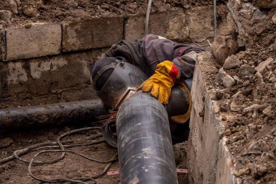 Close-up of a drainage pipe being inspected and repaired